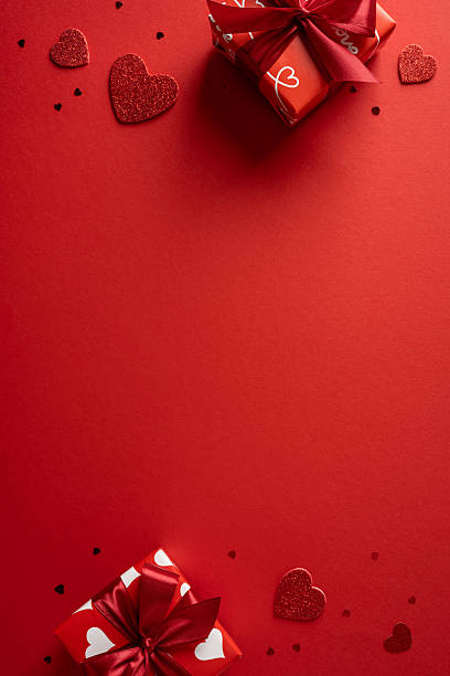 istock Bright vertical red backdrop features gift boxes with ribbons and glittering hearts, capturing a warm Valentine mood ideal for greeting cards, promos, and romantic campaigns 2253853711