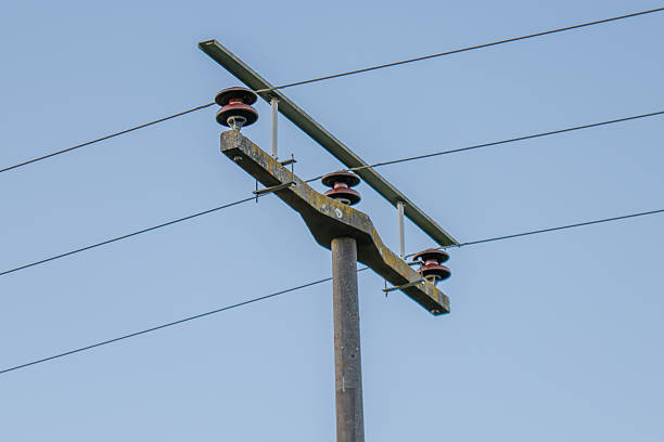 istock Electricity pole supplying power with cables against blue sky 2253853753