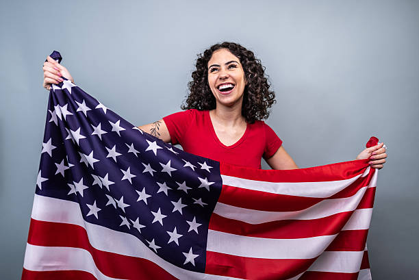 istock Passionate american fan celebrating with national flag 2253854488