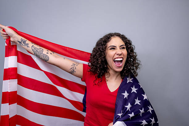 istock Passionate american fan celebrating with national flag 2253854489