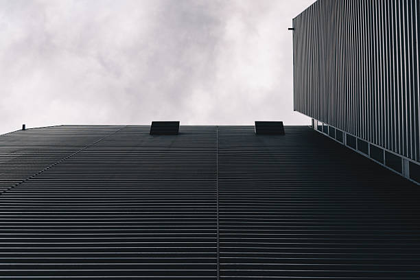 istock Minimalist Industrial Architecture With Corrugated Metal Facade and Cloudy Sky 2253855202