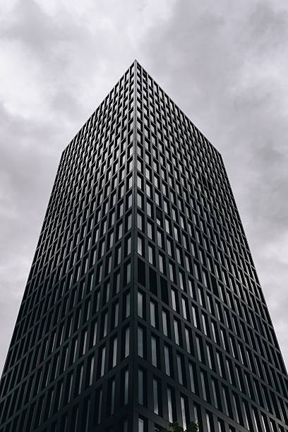 istock Minimalist Modern Office Building With Repeating Vertical Windows and Cloudy Sky 2253855217