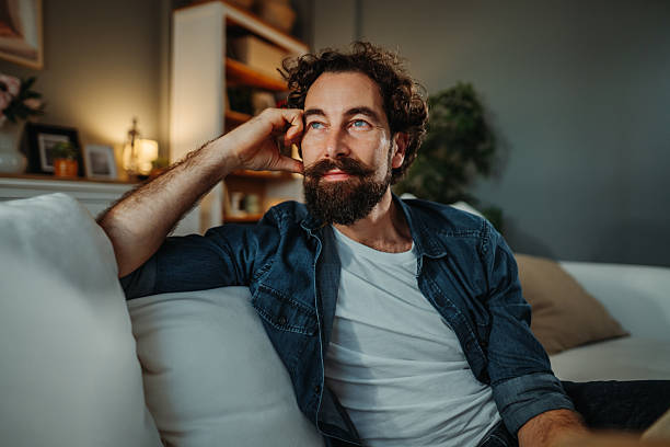 istock Thoughtful man relaxing home, lost in deep contemplation 2253856383
