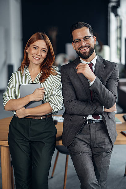 istock Happy professionals sharing ideas in bright office 2253858454