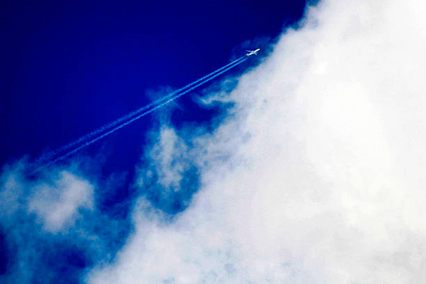 An airplane leaves a long contrail across a bright blue sky in Sydney, NSW, Australia. (Photo by Tara Chand Malhotra)