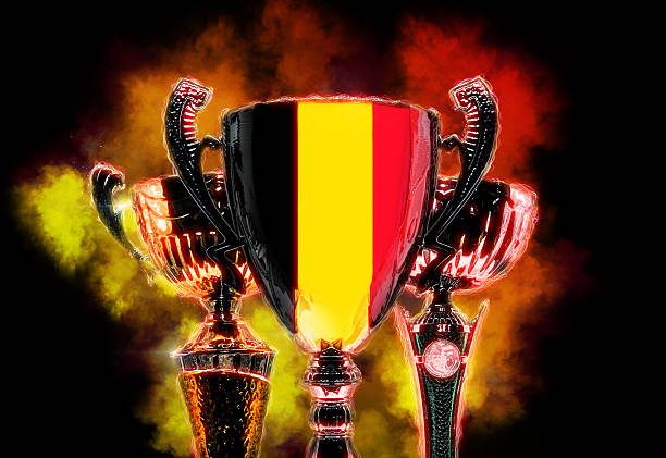 Closeup picrure of golden trophy. Soccer prize on grass soccer venue. Golden trophy with handles