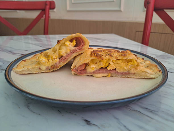 Calzone Smoked Beef Supreme with egg, mozzarella, cheese and smoked beef. Food Menu.