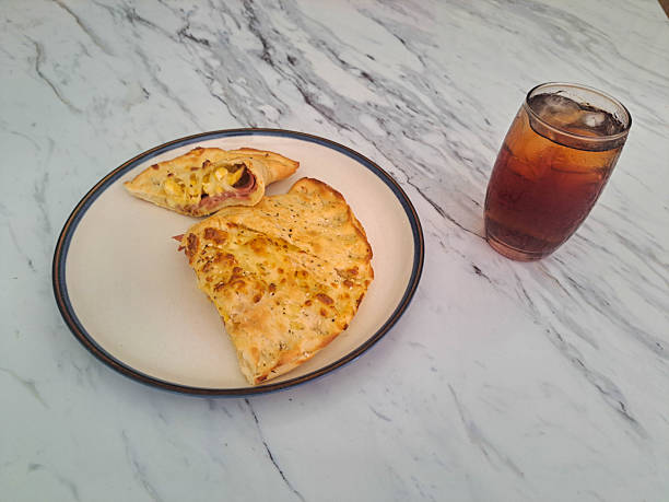 Calzone Smoked Beef Supreme with egg, mozzarella, cheese and smoked beef. Fresh Tea Iced in glass. Food And Drink Menu.