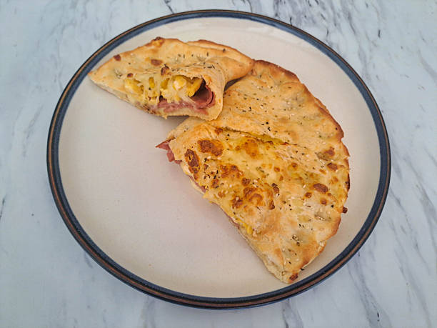 Delicious Calzone Smoked Beef Supreme with egg, mozzarella, cheese and smoked beef. Food Menu.