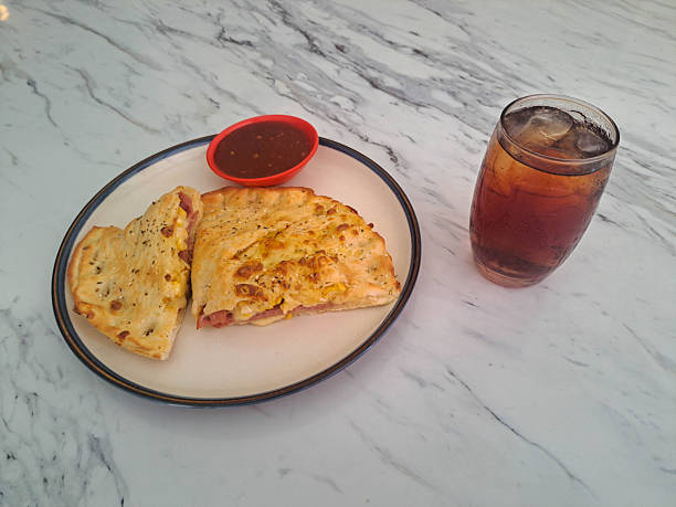 Calzone Smoked Beef Supreme with egg, mozzarella, cheese and smoked beef. Fresh Tea Iced in glass. Food And Drink Menu.