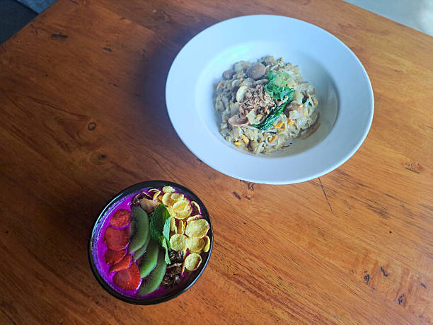 Dragon Smoothie Bowl with dragon fruit, banana, strawberry cornflakes cereal, granola, fresh milk and kiwi. Char Kway Teow Or Fried Kwetiau Or Kwetiaw Goreng With Chicken, Rice Noodles, Beansprout, Kale. Restaurant Menu.