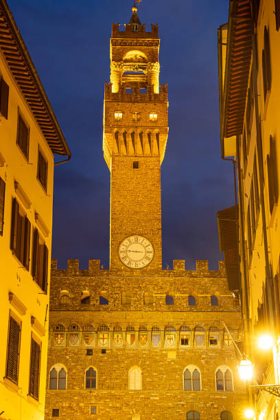 Florence, Italy, May, 18, 2023. Pallazo Vecchio and the Clock Tower in the Piazza della Signoria square at night in Florence, Italy