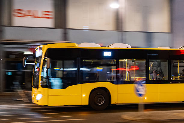 istock Yellow city bus in motion at night with blurred background 2253864947
