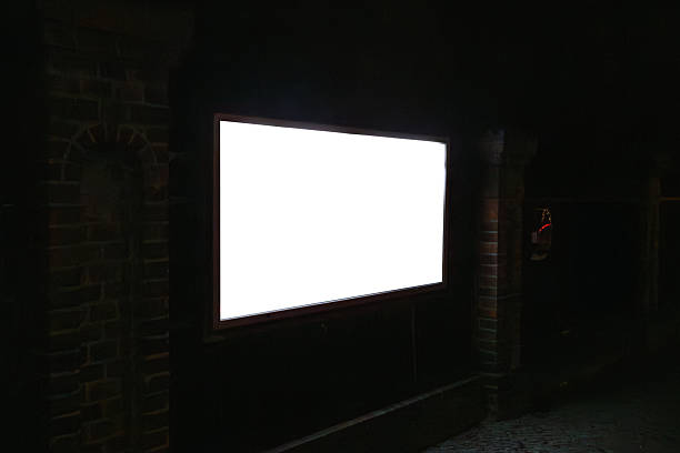 istock Horizontal blank illuminated billboard mockup mounted on brick wall at night 2253865504