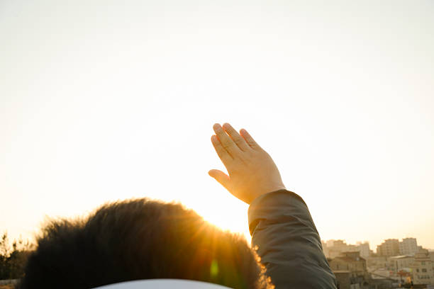 He raised his hand against the light and gently touched the setting sun.