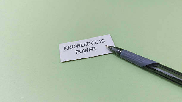istock Inspirational note with pen on green background saying knowledge is power 2253878005