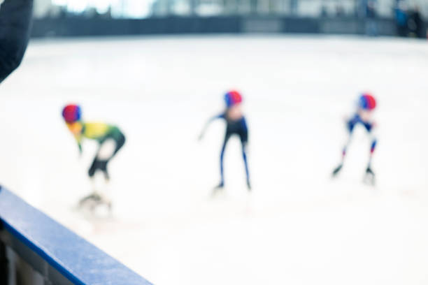 Speed skaters compete  at a speed skating race
