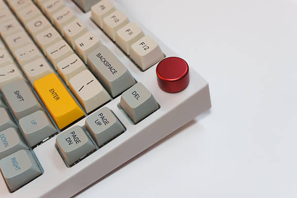 istock White mechanical keyboard with bright Enter key on white background, minimalism, keyboard buttons. A keyboard with a yellow key 2253883557