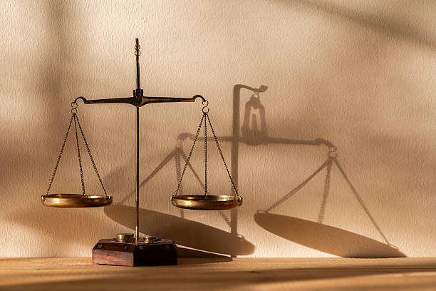 istock Golden scales of justice in a light and shadow drawing 2253884126