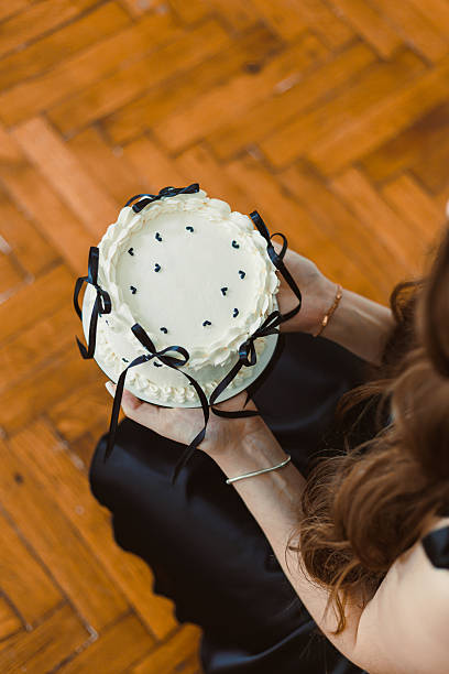 This elegant cake with luxurious black ribbons is a perfect centerpiece for celebrations, enhancing romantic anniversaries and lively birthday parties with class and delightful flavor