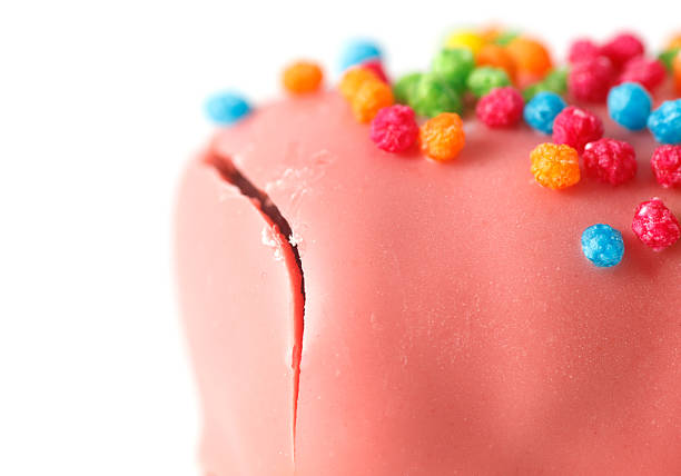 A pink dessert with colorful sprinkles on top. The sprinkles are in various colors and are scattered all over the dessert