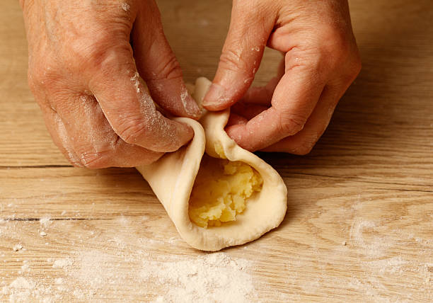 istock A person is making a pastry and is rolling it up 2253885505