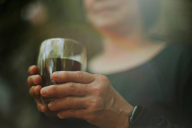 Close-up of a mature woman enjoying drinking coffee.