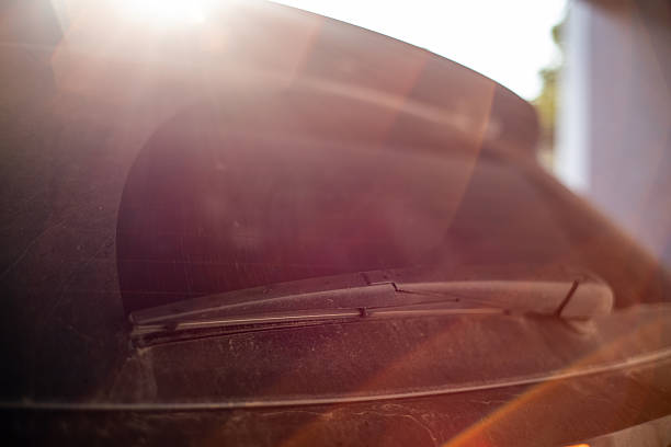 Dust has settled on the car with sunlight.