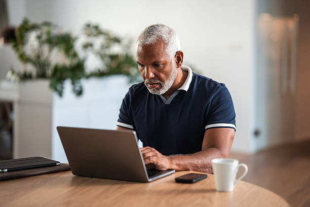 istock Worried Mature Hispanic Businessman Using Laptop in Modern Office 2253885974