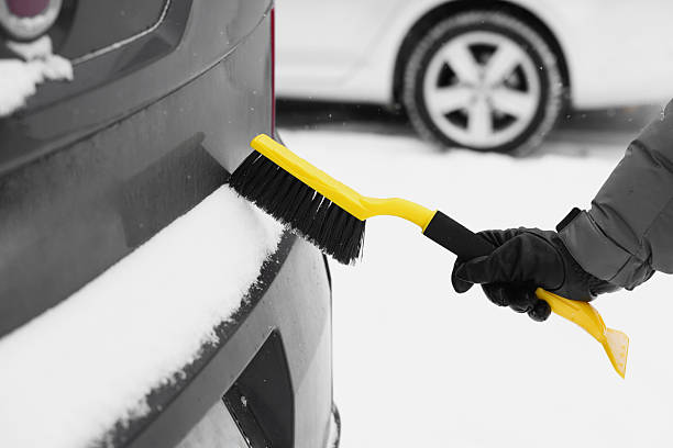 istock Man cleaning snow from car outdoors, closeup 2253886318