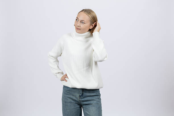 istock Pensive woman in a white sweater looking away 2253887458