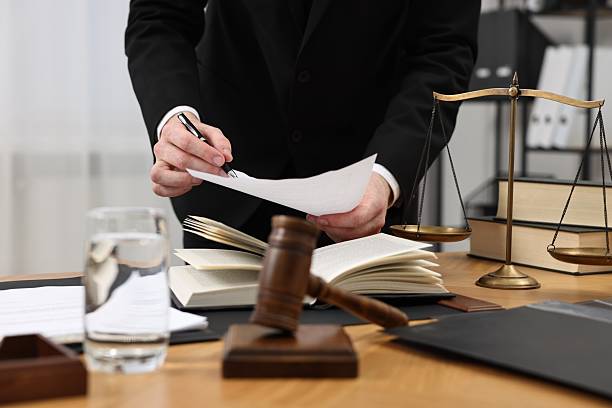 istock Lawyer working with document at wooden table, closeup 2253887847