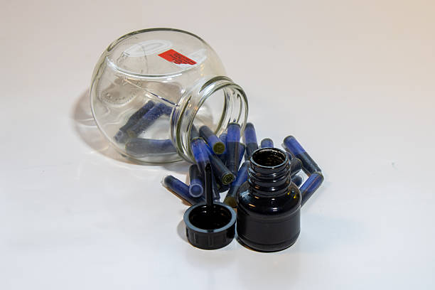Vintage retro pen and inkwell on paper background