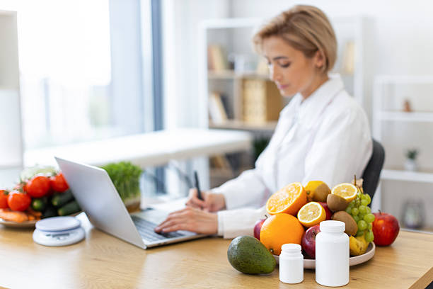 istock Nutritionist Working with Fruits and Laptop 2253889608