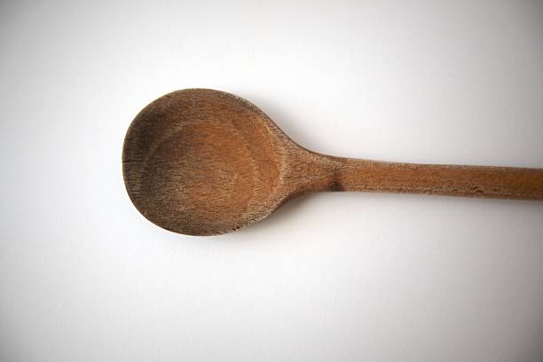 A little wooden spoon isolated on white background