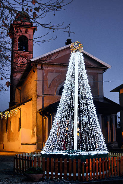 istock Illuminated Christmas Tree in Front of a Church at Dusk 2253894166