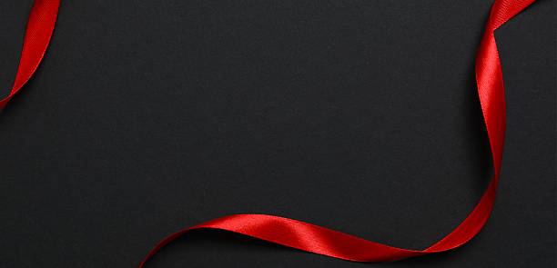 istock Stylish composition with red ribbon on black background, top view 2253894426