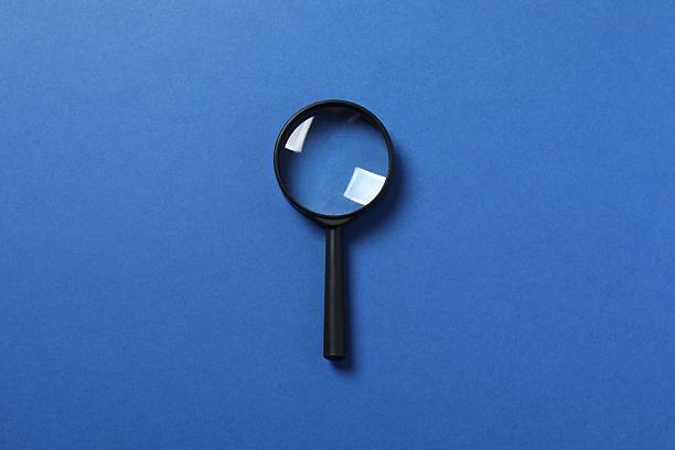 istock Magnifying glass on color background 2253894841