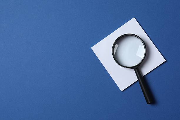 istock Magnifying glass with paper sticker on blue background 2253895459