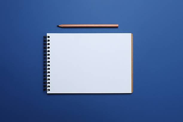 Flat lay with pencil and notebook on blue background, top view