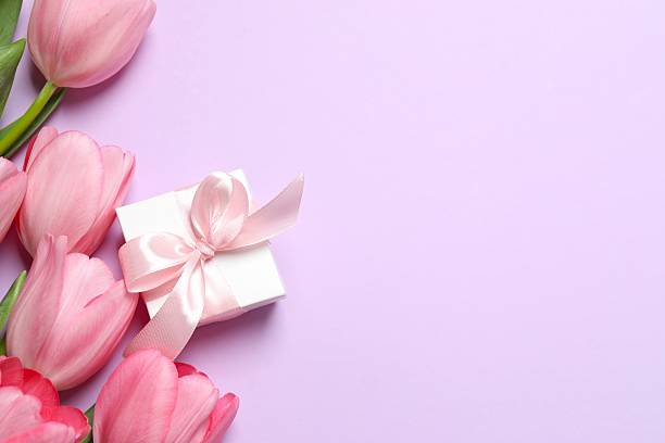 istock Beautiful fresh tulips with gift box on color background 2253895713