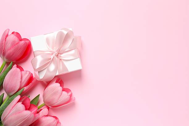 istock Beautiful fresh tulips with gift box on color background 2253895883