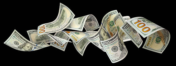 istock Flying hundred dollar banknotes, isolated on black background 2253896544