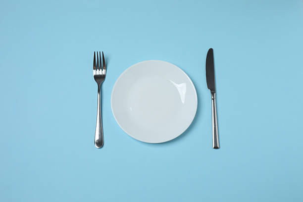 istock Empty plate and cutlery on colored background, top view 2253898722