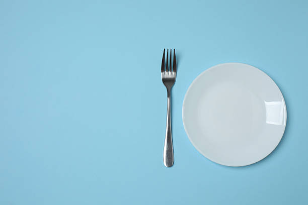 istock Empty plate and cutlery on colored background, top view 2253898729