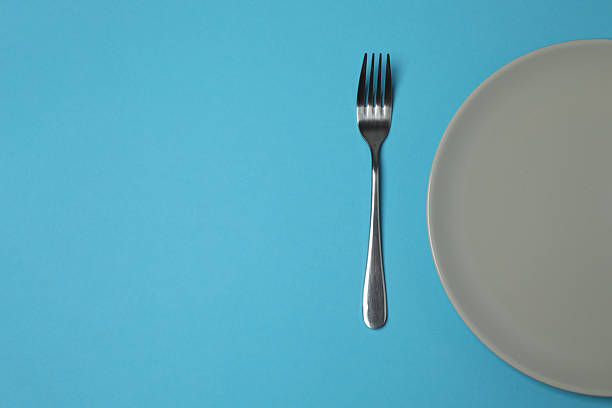 istock Empty plate and cutlery on colored background, top view 2253898756