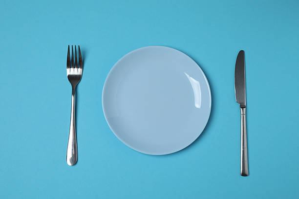 istock Empty plate and cutlery on colored background, top view 2253898762