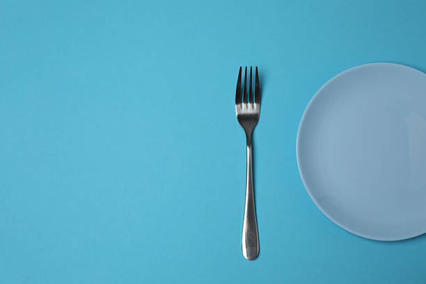 istock Empty plate and cutlery on colored background, top view 2253898773