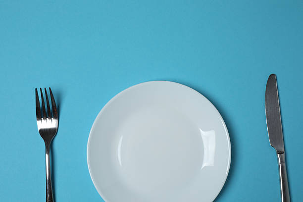 istock Empty plate and cutlery on colored background, top view 2253898774
