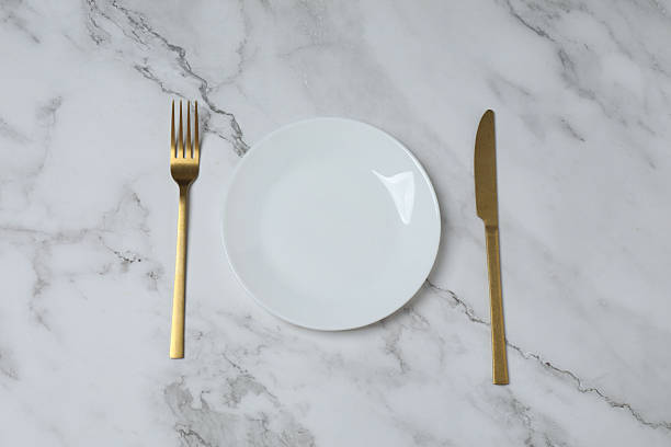 istock Empty plate and cutlery on colored background, top view 2253898781